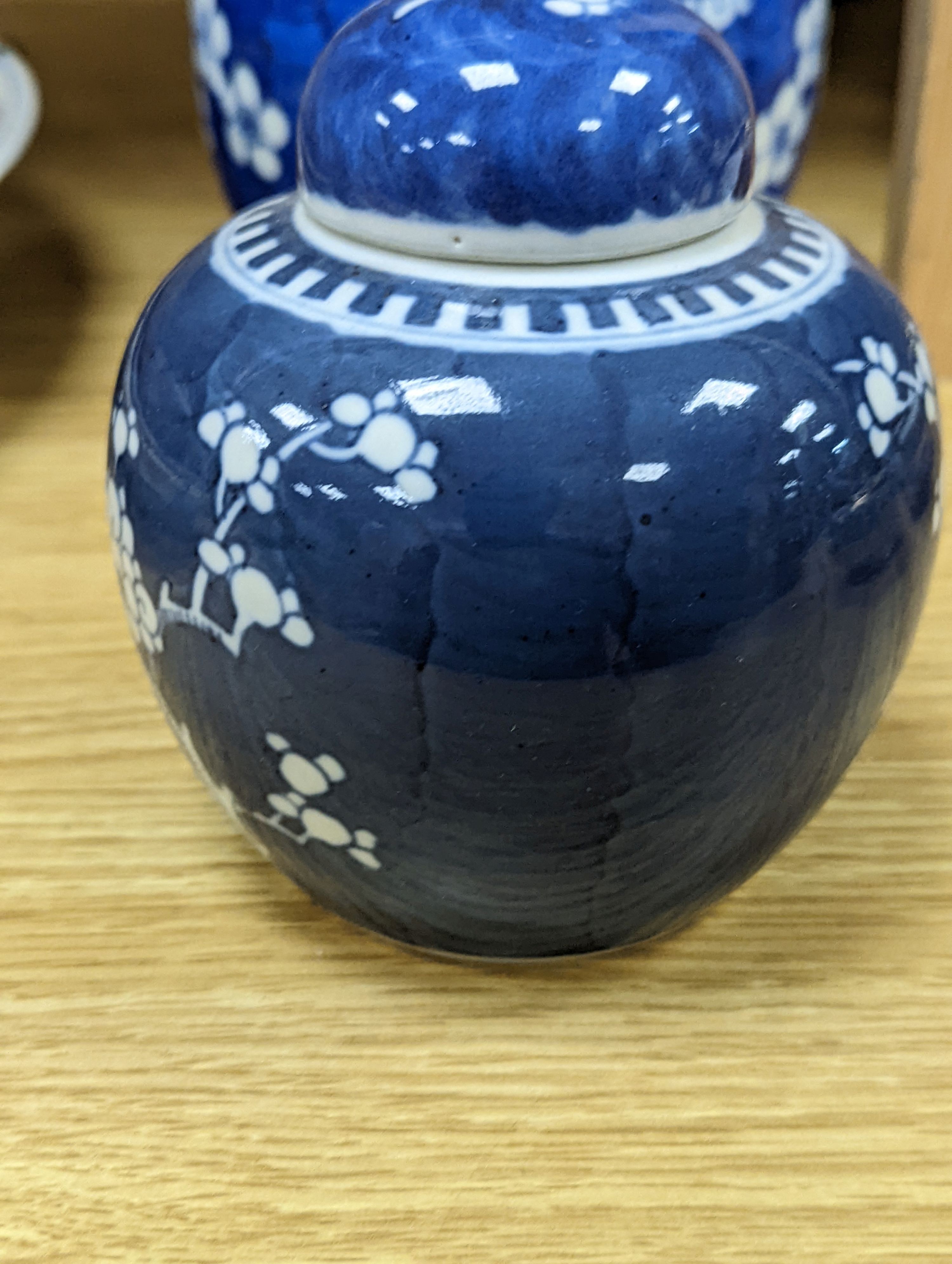 Three Chinese blue and white prunus decorated jars and covers, 19th/20th century, with four character marks 18cm